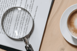 Close up shot of someone reviewing the fine print of their telco contract to see if they can claim a refund after a service outage