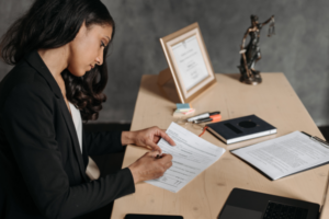 Woman reading legal documents trying to understand how class action works