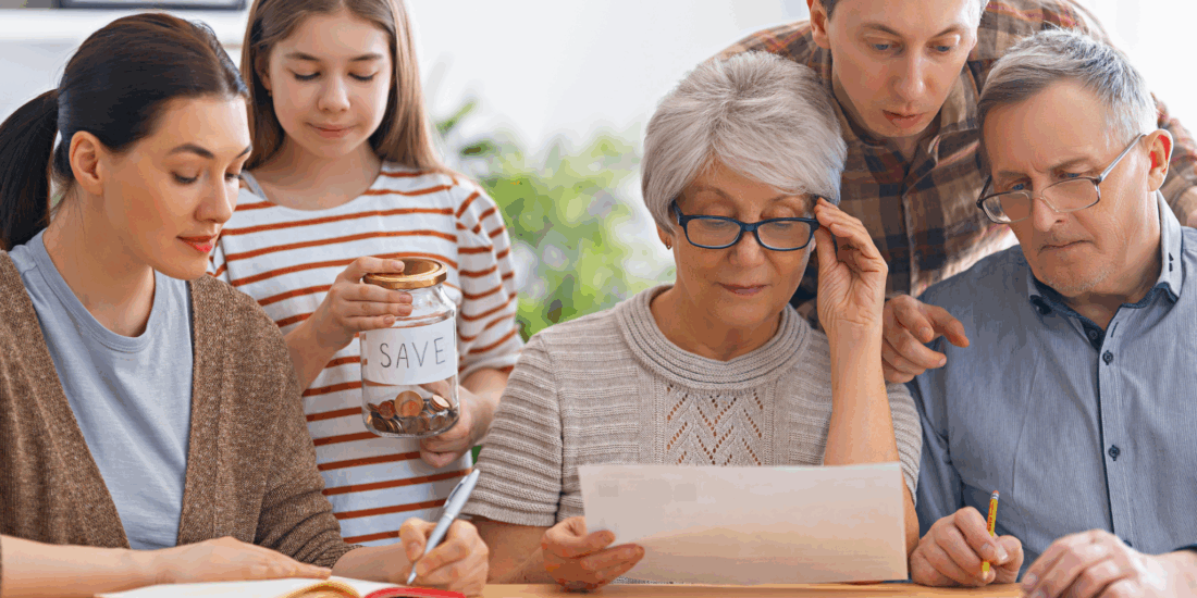 Family reviewing receipts and bills at home while calculating household costs and planning their budget