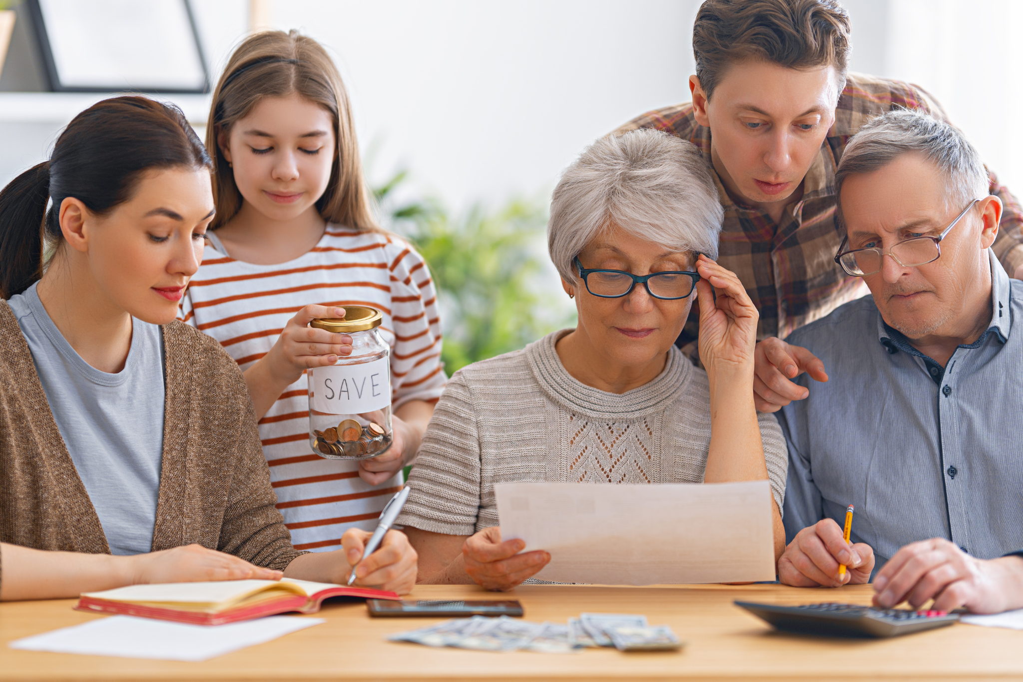 Family reviewing receipts and bills at home while calculating household costs and planning their budget