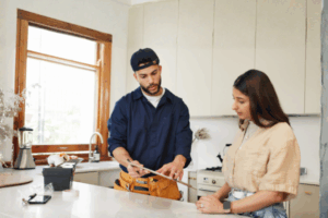 A homeowner talking to repairer about faulty Iplex pipes