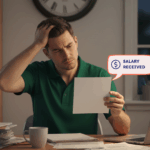 Woolworths employee reviewing payslip at home late at night