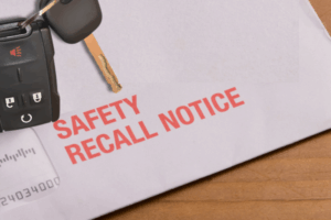 Close-up of a recall notice next to a Silverado key