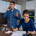 A couple reviewing their account statements and lodging a credit dispute with their provider.
