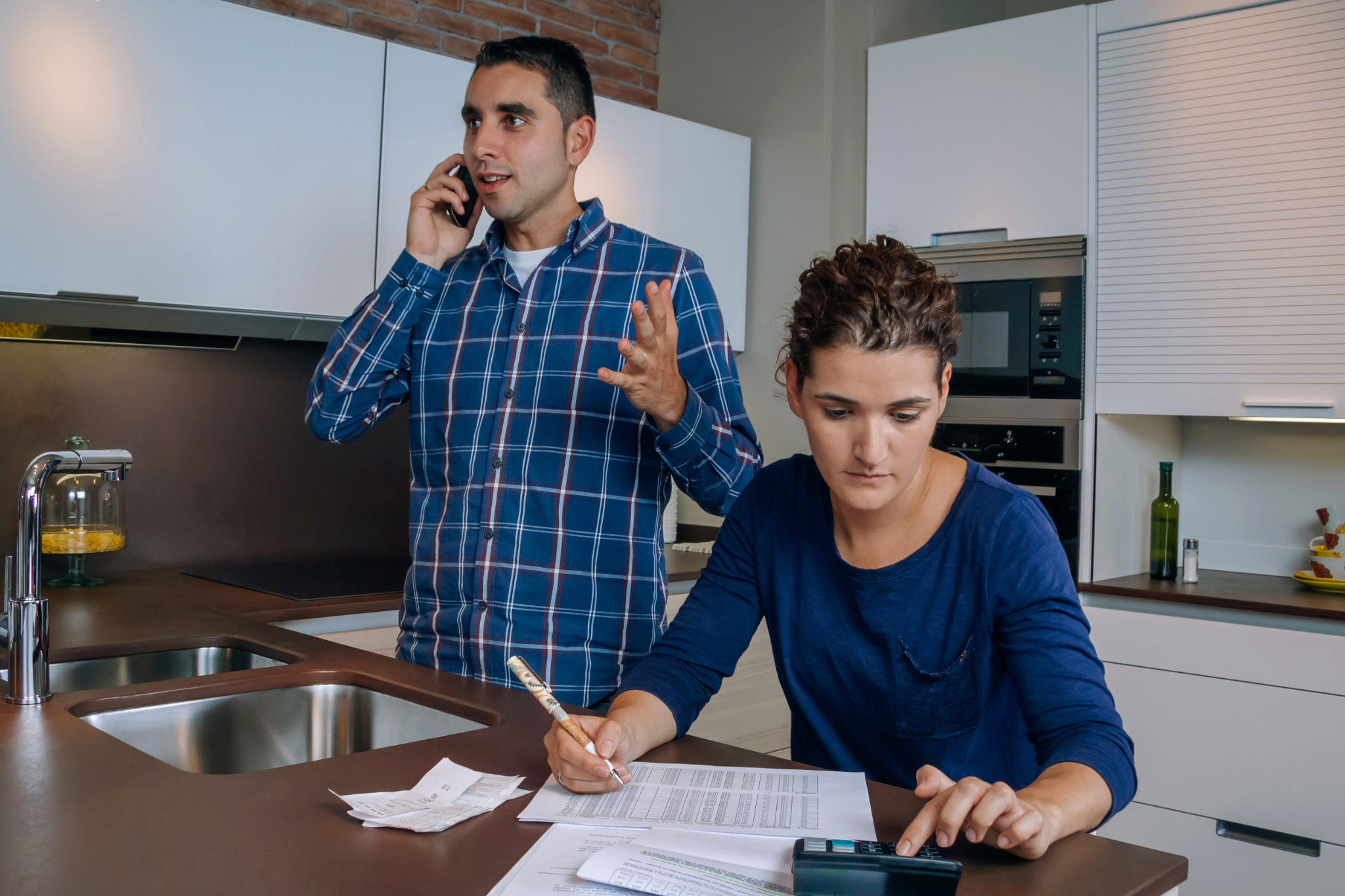 A couple reviewing their account statements and lodging a credit dispute with their provider.