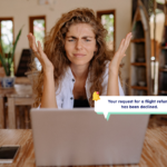 Frustrated woman looking at laptop showing a notification that her flight refund was declined