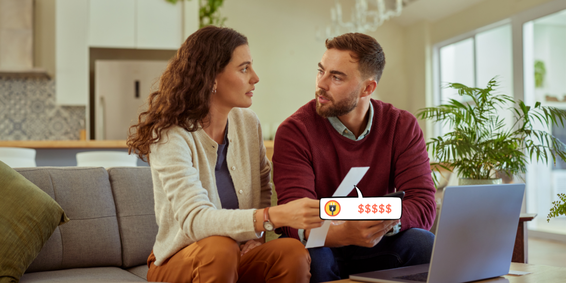 A couple sitting together looking concerned as they review their energy bills at home
