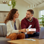 A couple sitting together looking concerned as they review their energy bills at home