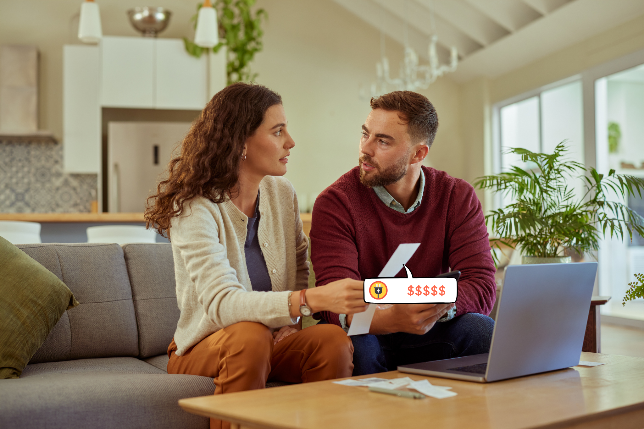 A couple sitting together looking concerned as they review their energy bills at home