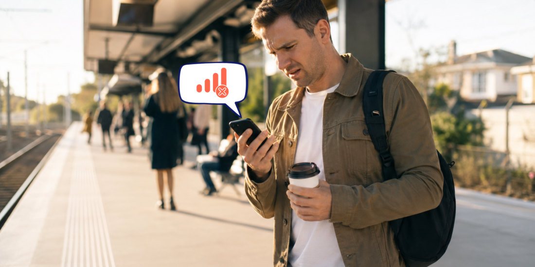 Australian commuter looking confused after a Telstra outage while waiting on a suburban train station platform