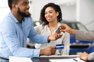 Couple using a credit card to pay for a rental car as part of protecting their car hire rights