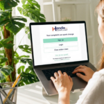 Woman making an electric vehicle complaint through Handle My Complaint (HMC) on a laptop